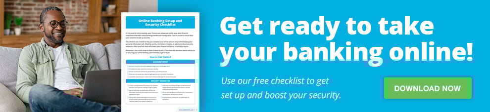 Man smiling at his laptop.